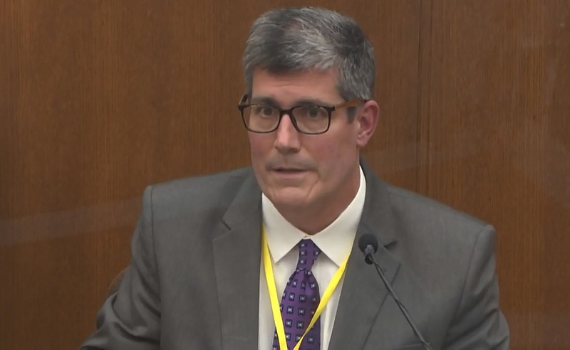 In this image from video, Dr. Andrew Baker, Hennepin County Medical Examiner, testifies as Hennepin County Judge Peter Cahill presides Friday, April 9, 2021, in the trial of former Minneapolis police Officer Derek Chauvin at the Hennepin County Courthouse in Minneapolis, Minn. Chauvin is charged in the May 25, 2020 death of George Floyd. (Court TV via AP, Pool)