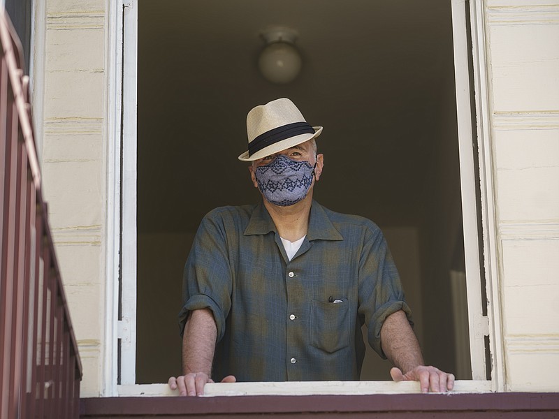 Nathan Long, a video game writer, poses for a picture inside his rental apartment in Glendale, Calif., Thursday, April 8, 2021. He and his wife, Lili, have been unsuccessful so far in their search for a home in Los Angeles. (AP Photo/Damian Dovarganes)