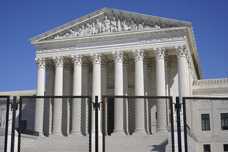 FILE - In this March 21, 2021, file photo security fencing surrounds the Supreme Court building on Capitol Hill in Washington. Biden on Friday, April 9, ordered a study of adding seats to the Supreme Court, creating a bipartisan commission that will spend the next 180 days examining the incendiary political issues of expanding the court and instituting term limits for justices on the highest bench. (AP Photo/Patrick Semansky, File)