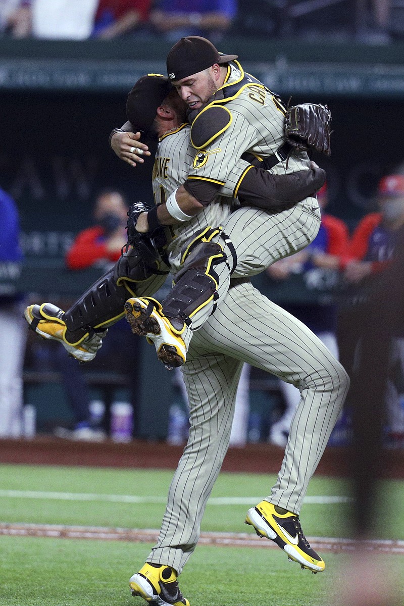 Padres starting pitcher Joe Musgrove gets a hug from catcher Victor Caratini after the final out in Friday night's no-hitter against the Rangers in San Diego.