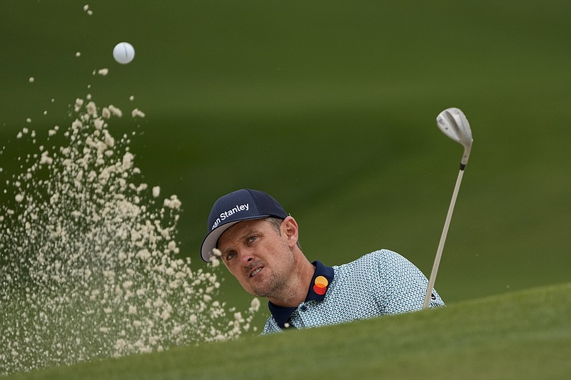 Justin Rose hits out of a bunker on the seventh hole during Friday's second round of the Masters in Augusta, Ga.