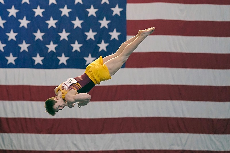 Michael Moran, representing the University of Minnesota, competes during the Winter Cup gymnastics event Sunday, Feb. 28, 2021, in Indianapolis. A junior from Morristown, New Jersey, Moran admits there were people within his inner circle who discouraged him from competing collegiately because they viewed his chosen sport as a "dying entity." The University of Minnesota and the University of Iowa will stop offering it as a scholarship sport at the end of the month. (AP Photo/Darron Cummings)