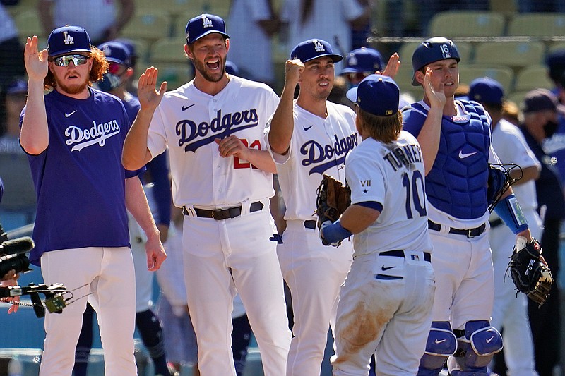 The Los Angeles Dodgers celebrate after a win over the Washington Nationals in a baseball game Friday, April 9, 2021, in Los Angeles. (AP Photo/Marcio Jose Sanchez)