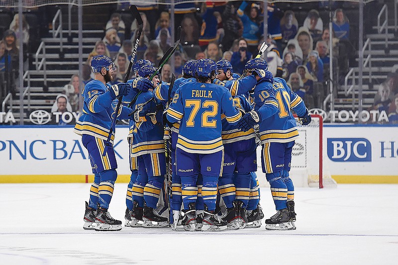 Ryan O'Reilly is surrounded by his Blues teammates after scoring the winning goal against the Wild late in overtime Saturday in St. Louis.