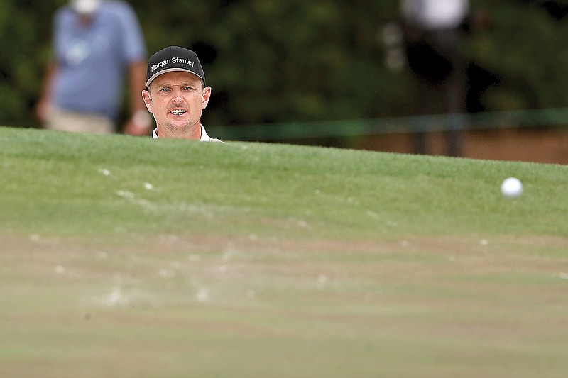 Justin Rose reacts to his shot on the fourth hole during Saturday's third round of the Masters at Augusta National in Augusta, Ga.