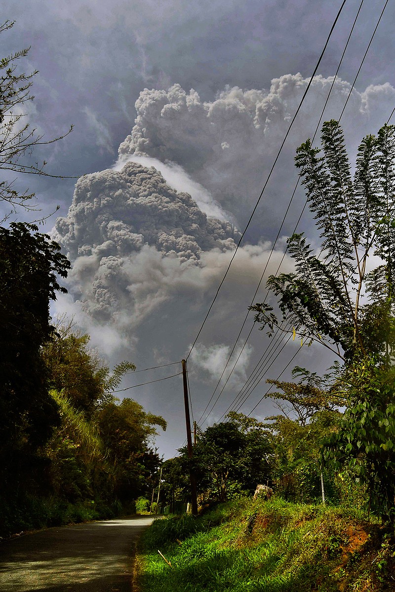 Plumes of ash rise from the La Soufriere volcano as it erupts on the eastern Caribbean island of St. Vincent, as seen from Chateaubelair, Friday, April 9, 2021. (AP Photo/Orvil Samuel)