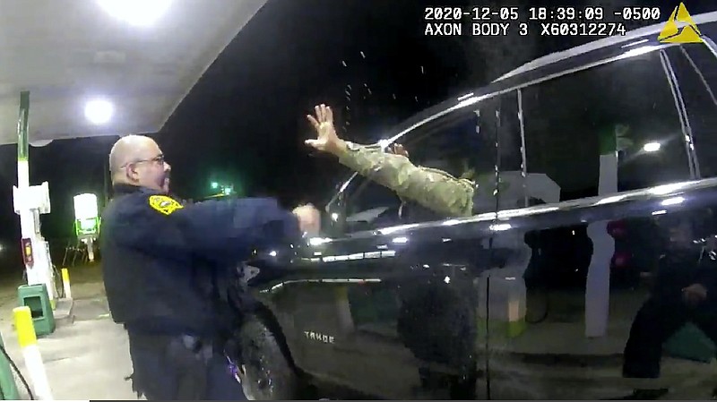 In this image made from Windsor, (Va.) Police video, A police officer uses a spray agent on Caron Nazario on Dec. 20, 2020, in Windsor, Va.  Nazario, a second lieutenant in the U.S. Army, is suing two Virginia police officers over a traffic stop during which he says the officers drew their guns and pointed them at him as he was dressed in uniform. Caron Nazario says his constitutional rights were violated by the traffic stop in the town of Windsor in December.  (Windsor Police via AP)