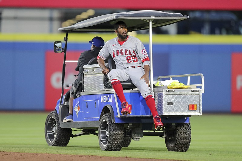 Dexter Fowler of the Angels is carted off after a play at second base against the Blue Jays on Friday night in Dunedin, Fla.