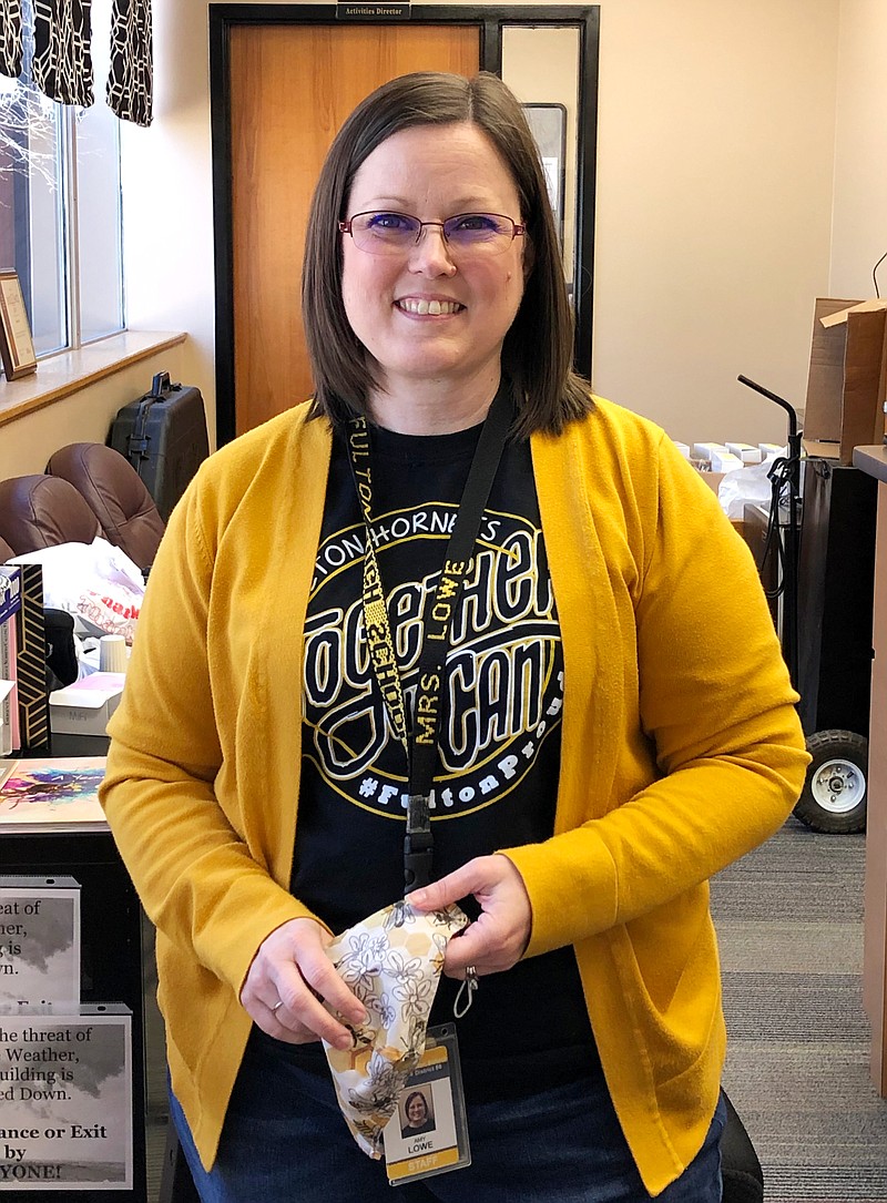 Amy Lowe takes a brief break Friday morning from her job as administrative assistant at Fulton High School. 