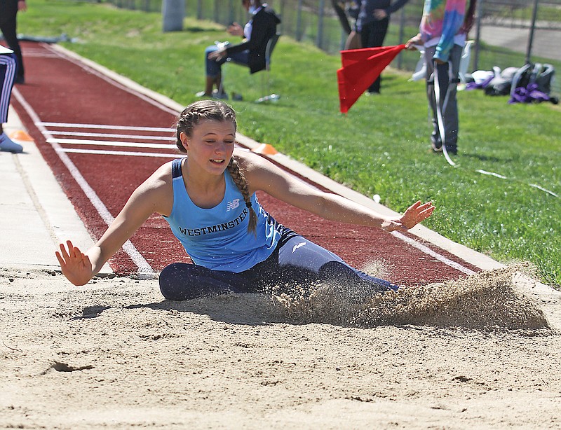 Westminster's Katy Allen splashes into the sand during one of her attempts in the women's triple jump Sunday in the Lincoln Open at Dwight T. Reed Stadium.