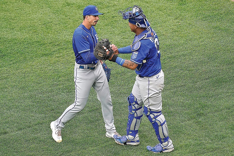Royals pitcher Kyle Zimmer celebrates with catcher Salvador Perez after Sunday afternoon's 4-3 win against the White Sox in Chicago.
