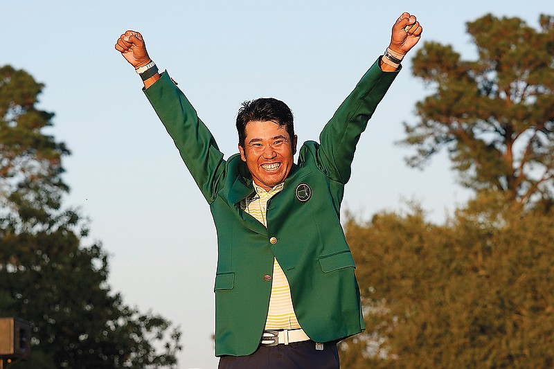 Hideki Matsuyama celebrates after putting on the champion's green jacket Sunday after winning the Masters in Augusta, Ga.