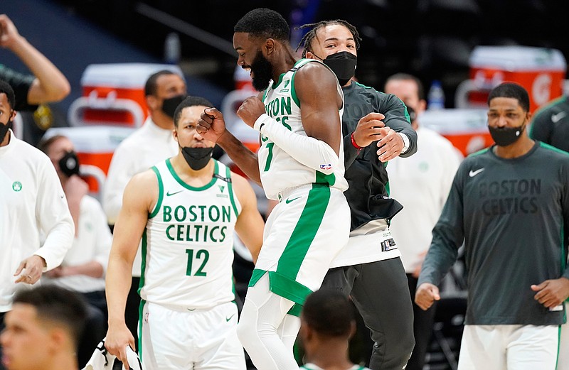 Boston Celtics guard Jaylen Brown, front left, celebrates with guard Carsen Edwards late in the second half of an NBA basketball game against the Denver Nuggets, Sunday, April 11, 2021, in Denver. (AP Photo/David Zalubowski)