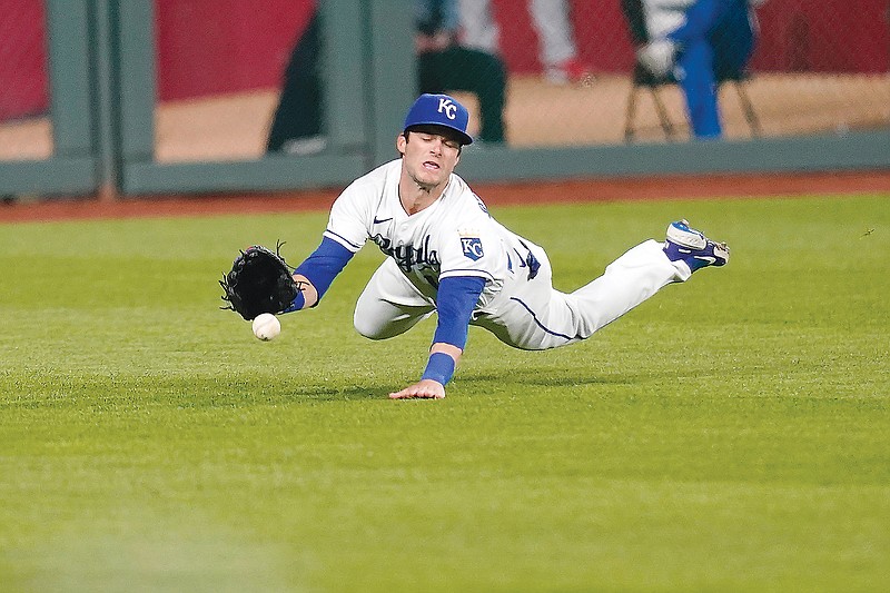 Royals left fielder Andrew Benintendi dives in an attempt to catch a fly ball hit by Shohei Ohtani of the Angels during the ninth inning of Monday night's game at Kauffman Stadium.