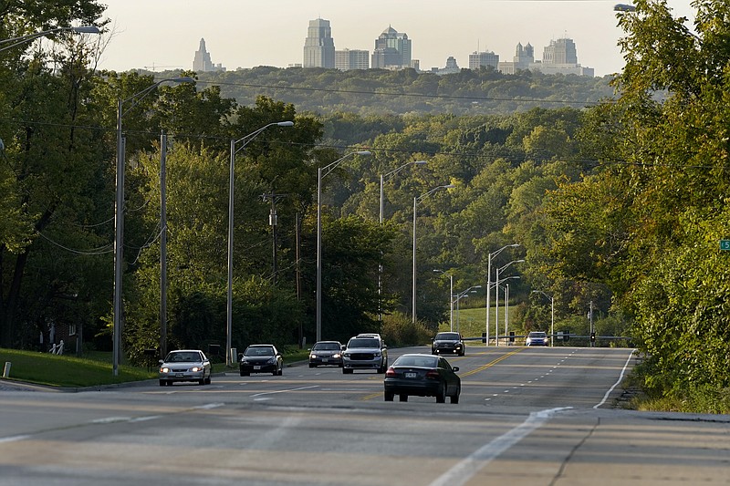 FILE - In this Sept. 24, 2020, file photo, cars travel on a stretch of Blue Parkway in Kansas City, Mo. After years of debate and a divisive election, Kansas City will soon have a street route named for Martin Luther King Jr., removing its designation as one of the largest city's in the U.S. to not have a street named for the civil rights icon. On Tuesday, April 13, 2021, the city's Board of Parks and Recreation approved a plan to name a 5-mile stretch that runs east to west for King, which includes Blue Parkway. (AP Photo/Charlie Riedel, File)