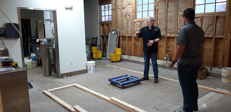 Mark Mize, director of operations for Silver Star Inc., works with Donnie Spriggs, Silver Star Texarkana general manager, on the layout for their new kitchen and food preparation area, discussing positioning of the various implements.