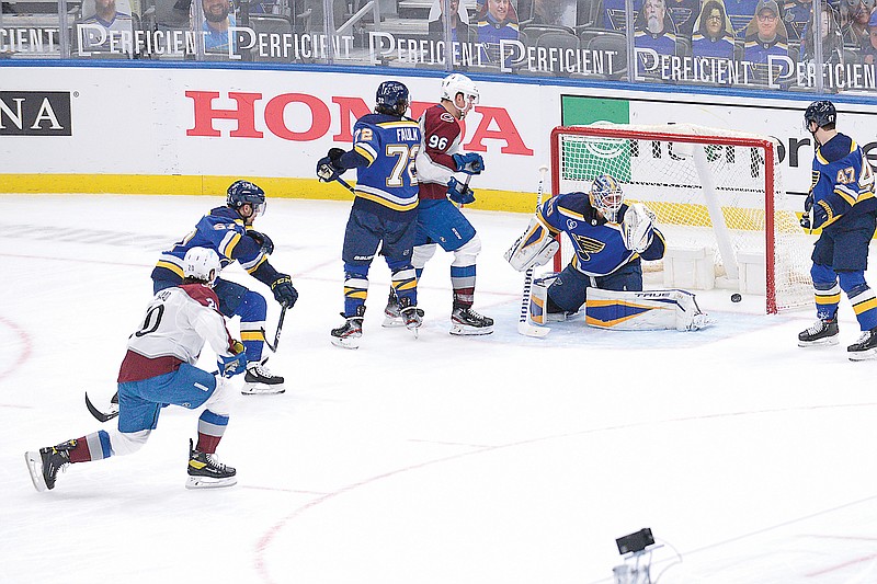 Brandon Saad (left) of the Avalanche scores a goal past Blues goaltender Jordan Binnington during the second period of Wednesday's game in St. Louis.