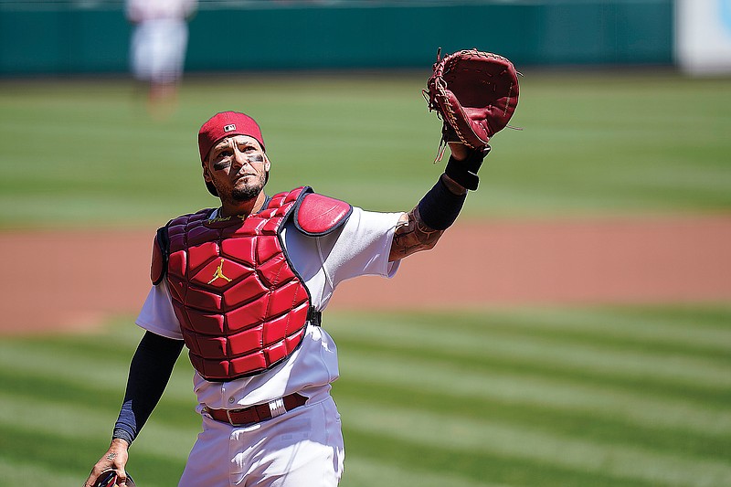 Cardinals catcher Yadier Molina waves to cheering fans after the first pitch of Wednesday afternoon's game against the Nationals at Busch Stadium. It was the 2,000th career game at catcher for Molina.