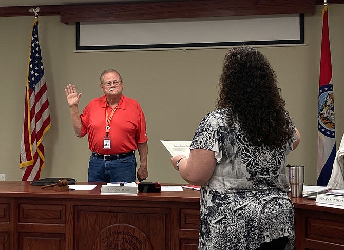 City Clerk Rachel Anderson swears in Mike Harvey, who was re-elected as Ward 1 council member in the 2021 General Municipal Election on Tuesday.