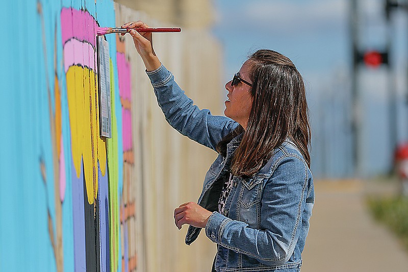 Liv Paggiarino/News Tribune

Amy Greenbank continues working on the mural along Capitol Avenue, near Avenue Q, on a sunny and temperate Thursday afternoon.
