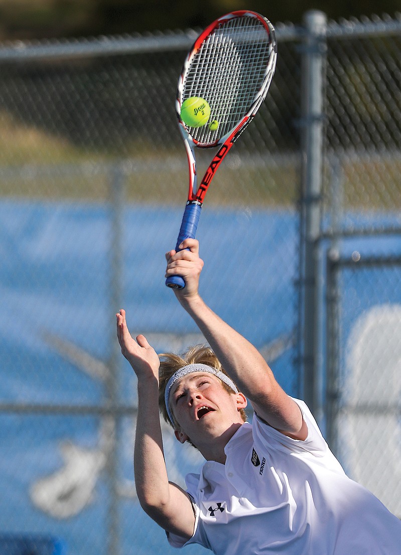 Jacob Zerr of Helias serves the ball April 15, 2021, during a dual against Capital City at Capital City High School.