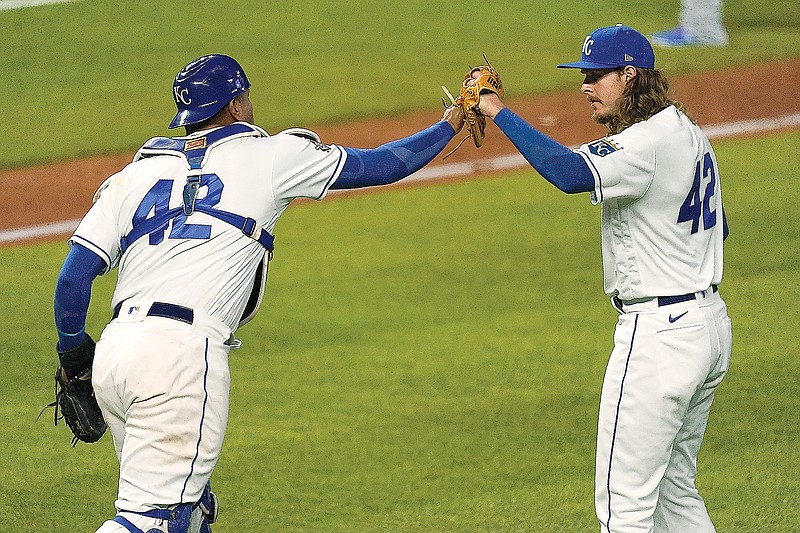 Royals catcher Salvador Perez and pitcher Scott Barlow celebrate after Thursday night's 7-5 victory against the Blue Jays at Kauffman Stadium.