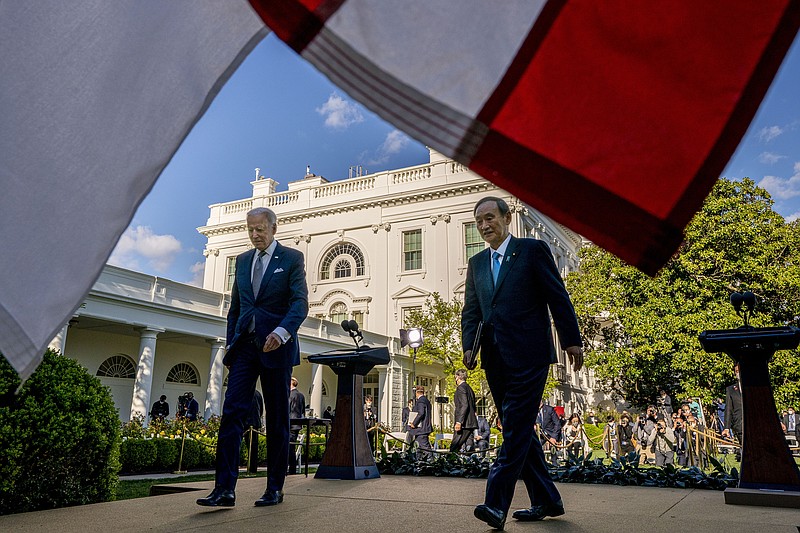 President Joe Biden and Japanese Prime Minister Yoshihide Suga leave a news conference in the Rose Garden of the White House in Washington, Friday, April 16, 2021. (AP Photo/Andrew Harnik)