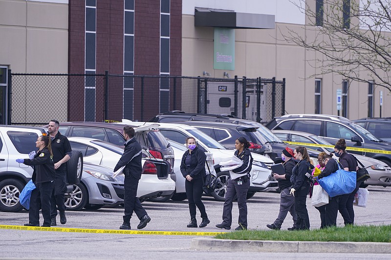 Law enforcement confer at the scene, Friday, April 16, 2021, in Indianapolis, where multiple people were shot at a FedEx Ground facility near the Indianapolis airport. (AP Photo/Michael Conroy)