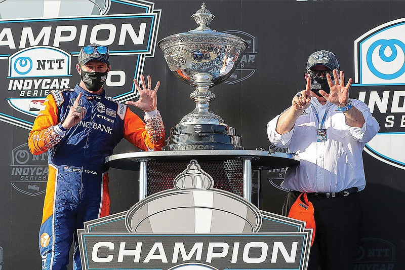 In this Oct. 25, 2020, file photo, Scott Dixon and team owner Chip Ganassi celebrate after winning the NTT IndyCar Series Championship following a race in St. Petersburg, Fla.