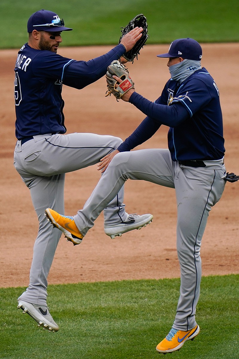 Tampa Bay Rays' Kevin Kiermaier, left, celebrates with teammate Willy Adames, right, after a baseball game against the New York Yankees Saturday, April 17, 2021, in New York. The Rays won 6-3. (AP Photo/Frank Franklin II)