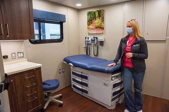 Kyra Clevenger, COO of Community Health Center of Central Missouri, stands in one of two exam rooms in the center's new mobile unite. Using federal COVID-relief money administered by the Cole County Commission, Community Health was able to purchase this vehicle which contains three rooms.