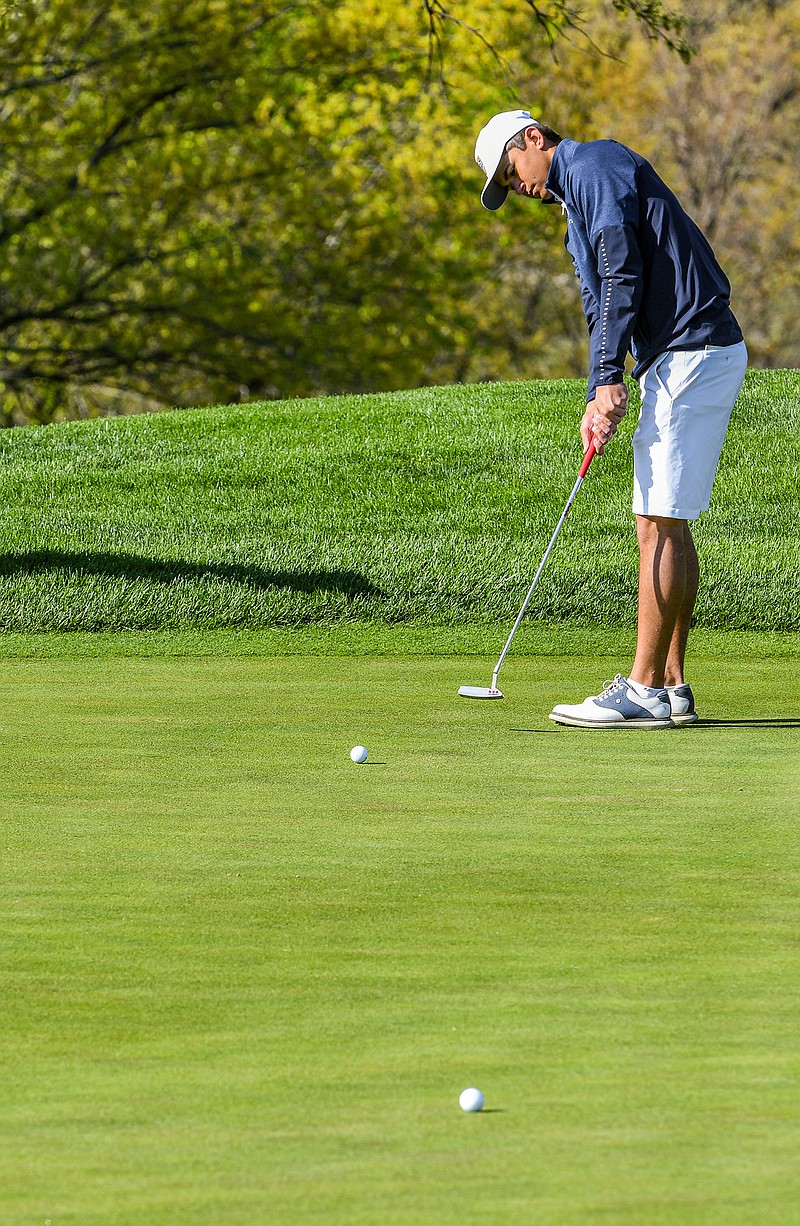 Davis Linhardt of Helias watches his putt during Monday's action in the Helias Invitational at Jefferson City Country Club.