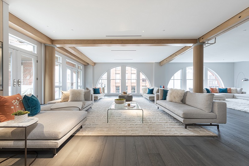 An expansive loft space is furnished with a mix of sofas used to create different conversation areas. (Design Recipes/TNS)
