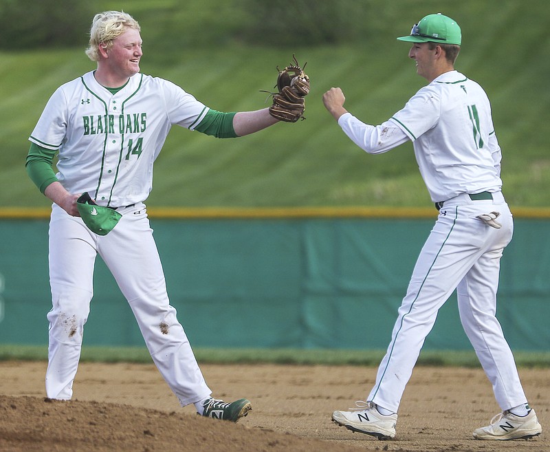 Blair Oaks pitcher Cale Willson (left) and first baseman Gavin Wekenborg bump fists after nearly colliding to grab an infield popup during Wednesday's 6-2 win against Boonville at the Falcon Athletic Complex in Wardsville.