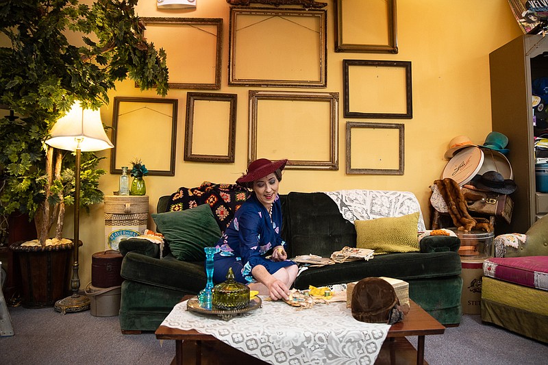 Tonia Chambers sits in her space filled with vintage items in the back of Caveman Consignment on Tuesday. Chambers loaned over 90 pieces of 1970s clothing to Texarkana Museum Systems for its fashion show, From Pinafores to Polyester, on Saturday at the P.J. Ahern Home.
