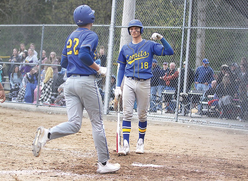 Fatima's Dean Hagenhoff (right) greets Gage Cunningham at home plate after Cunningham hit a solo home run in the bottom of the sixth inning of Thursday's game against Blair Oaks at Lions Field in Westphalia.