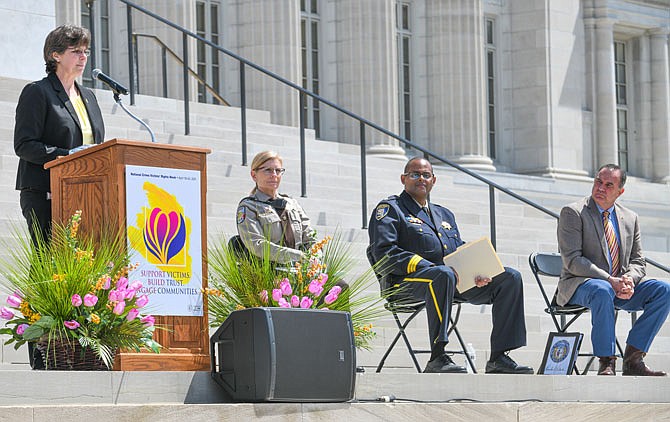 Sandy Karsten, director of the Missouri Department of Public Safety, addresses those in attendance Thursday at the Missouri Crime Victims' Ceremony at the Missouri Capitol. She expressed gratitude to personnel from several state and affiliated agencies who try to help victims of crimes, including domestic violence. Seated, to the right, are Cape Girardeau County Sheriff Ruth Ann Dickerson; Major Erik Holland, of the Platte County Sheriff's Office; and Lt. Gov. Mike Kehoe.