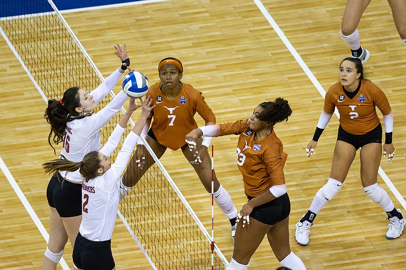Texas' Logan Eggleston (33) scores the final point against Wisconsin's Sydney Hilley (2) and Dana Rettke (16) during a semifinal in the NCAA women's volleyball championships Thursday, April 22, 2021, in Omaha, Neb. (AP Photo/John Peterson)
