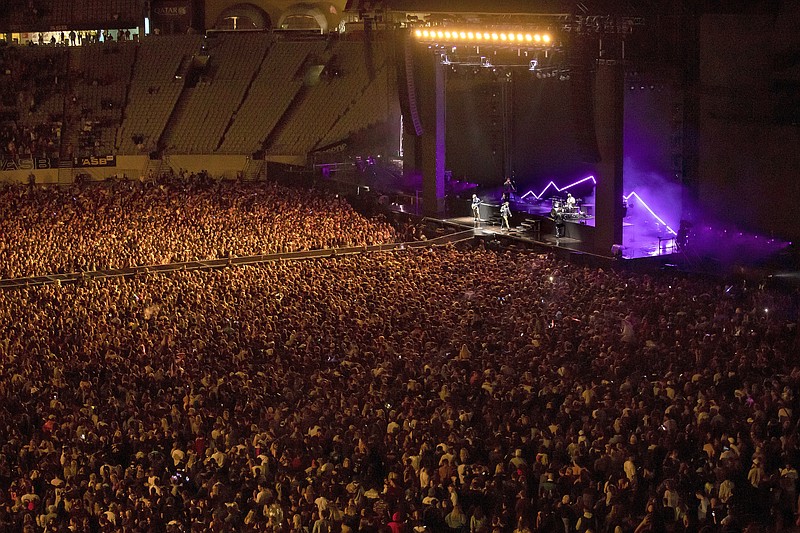 New Zealand band Six60 perform at Eden Park in Auckland, New Zealand, Saturday, April 24, 2021. Six60 is being billed as the biggest live act in the world since the coronavirus pandemic struck after New Zealand stamped out the spread of the virus, allowing life to return to normal. On Saturday, the band played a remarkable finale to their latest tour, performing in front of 50,000 people at the first-ever concert at Auckland's Eden Park.(AP Photo/David Rowland)