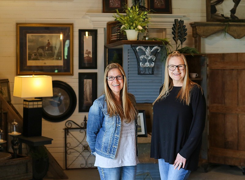 Mary Gardner and Sheila Owens stand inside their new business, Southern Willow Interiors in New Bloomfield. Gardner and Owens used the skeleton of an old local barn to create the main building of the store, refurbishing it as much as they've refurbished much of the furniture on sale inside.