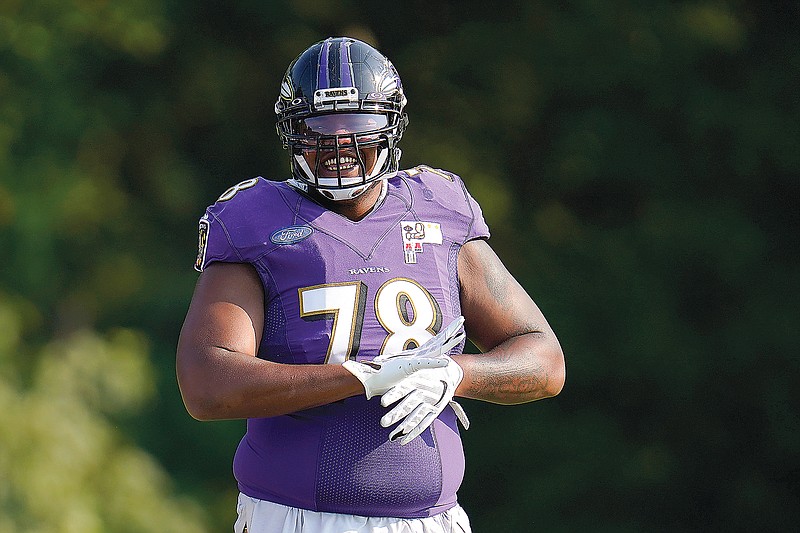 In this Aug. 25, 2020, file photo, Ravens offensive tackle Orlando Brown Jr. reacts after running a drill during an NFL training camp practice in Owings Mills, Md.