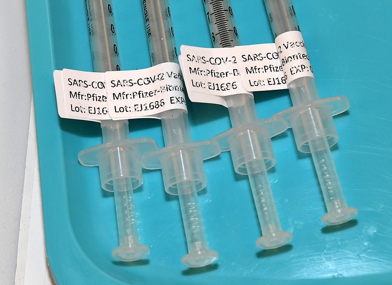 Syringes with the Pfizer-BioNTech COVID-19 vaccine are placed on a tray as vaccinations are administered on the UNLV campus on January 12, 2021, in Las Vegas. (Ethan Miller/Getty Images/TNS)