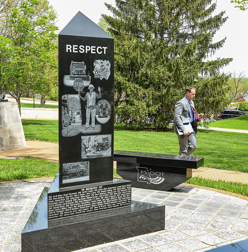 Julie Smith/News Tribune
Ryan DeBoef is seen walking past the monument on the grounds of MoDOT headquarters on Capitol Avenue Monday. DeBoef is in government relations for Missouri State University and frequently passes this marker on his way to and from the Capitol building. MoDOT officials held a briefing using Facebook Live in the morning to raise awareness about safe driving and operations in construction work zones. Incidents involving work zones either involving speeding or distracted drivers were up dramatically in 2020 over 2019. This area set aside at the headquarters is to recognized those MoDOT workers who have lost their lives while working in construction zones.