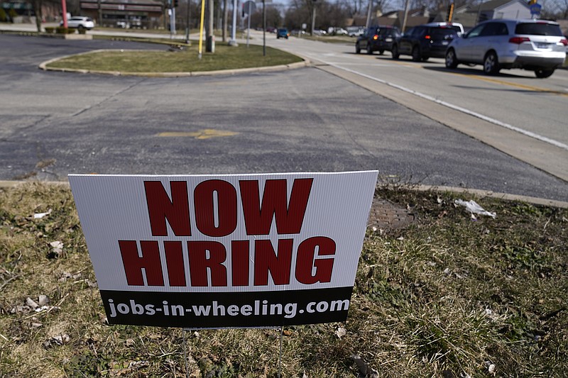 A hiring sign shows in Wheeling, Ill., Sunday, March 21, 2021.  The number of Americans applying for unemployment aid fell last week to 547,000, a new low since the pandemic struck and a further encouraging sign that layoffs are slowing on the strength of an improving job market. The Labor Department said Thursday, April 22,  that applications declined 39,000 from a revised 586,000 a week earlier. (AP Photo/Nam Y. Huh)