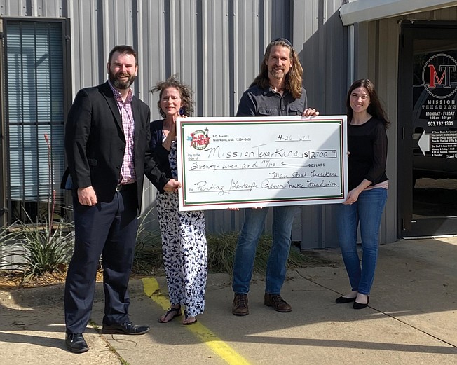 From left, James Bright, Ina McDowell, Cody Howard and Alaina Presley with the $2,700 check presented to Mission Texarkana by Main Street Texarkana.