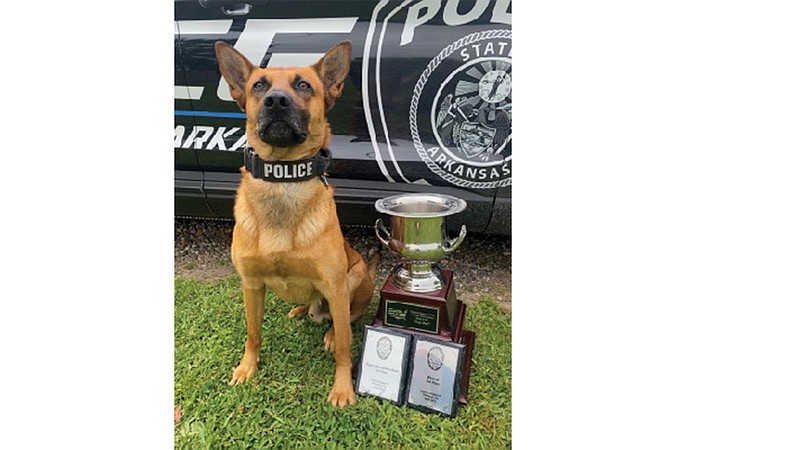 Texarkana, Arkansas, Police K-9 Officer Kashko' poses with several awards they won, including the Top Dog Award, at the United States Police Canine Association (USPCA) Region 20 Canine certification and competition in Sherman, Texas, earlier this month.