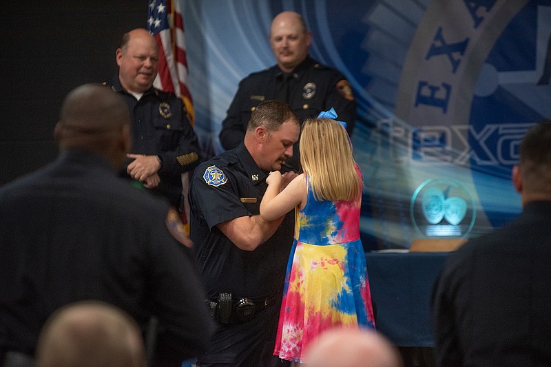 Nicholas Smith is pinned with his badge upon graduating from the East Texas Police Academy Class 327 Tuesday afternoon. Smith is assigned to the fire marshal's office.
