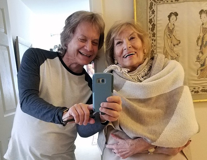 Leland Stein, left, takes a photo with his mother Sondra Green in her apartment in New York on April 26, 2018. The two are reuniting in person for Mother’s Day as vaccinations have made families feel more comfortable gathering for the holiday. (Leland Stein via AP)