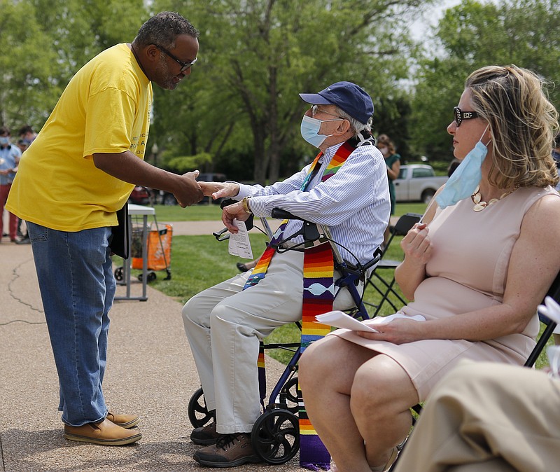 Liv Paggiarino/News Tribune

Missouri NAACP President Rod Chapel, left, shakes hands with the Rev. John Bennett, a retired First Christian Church minister before Tuesday’s Medicaid expansion rally in front of the Missouri State Capitol. Bennett, a longtime local activist, said the opening prayer for the rally. Both Chapel and Bennett were involved in Medicaid 23, an activism group dedicated to advocating for Medicaid in Missouri. Chapel, a lawyer, represented Bennett and six other clergymen in 2014 when they were arrested after protesting Missouri’s failure to expand Medicaid in the Senate gallery in 2011. In total, 23 people were arrested during that protest, leading to the group’s name, Medicaid 23. 