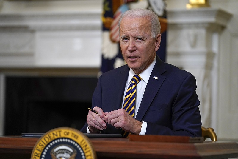 FILE - In this Feb. 24, 2021, file photo, President Joe Biden pauses after signing an executive order relating to U.S. supply chains, in the State Dining Room of the White House in Washington. Biden is preparing to sign an executive order to increase the minimum wage to $15 an hour for federal contractors. Administration officials say it will provide a pay bump to hundreds of thousands. (AP Photo/Evan Vucci, File)